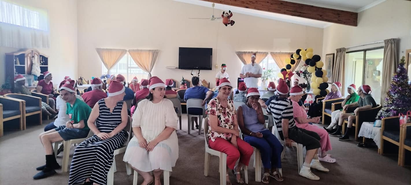Residents sitting in a circle playing games