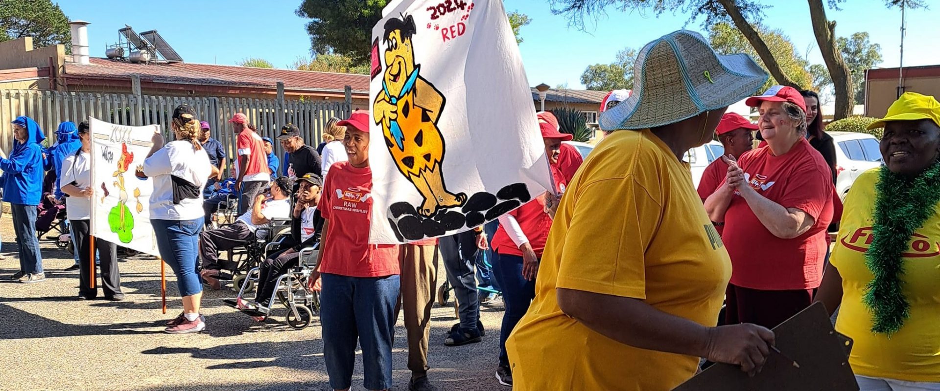 Vita Noveans standing in their respective teams with their homemade flags
