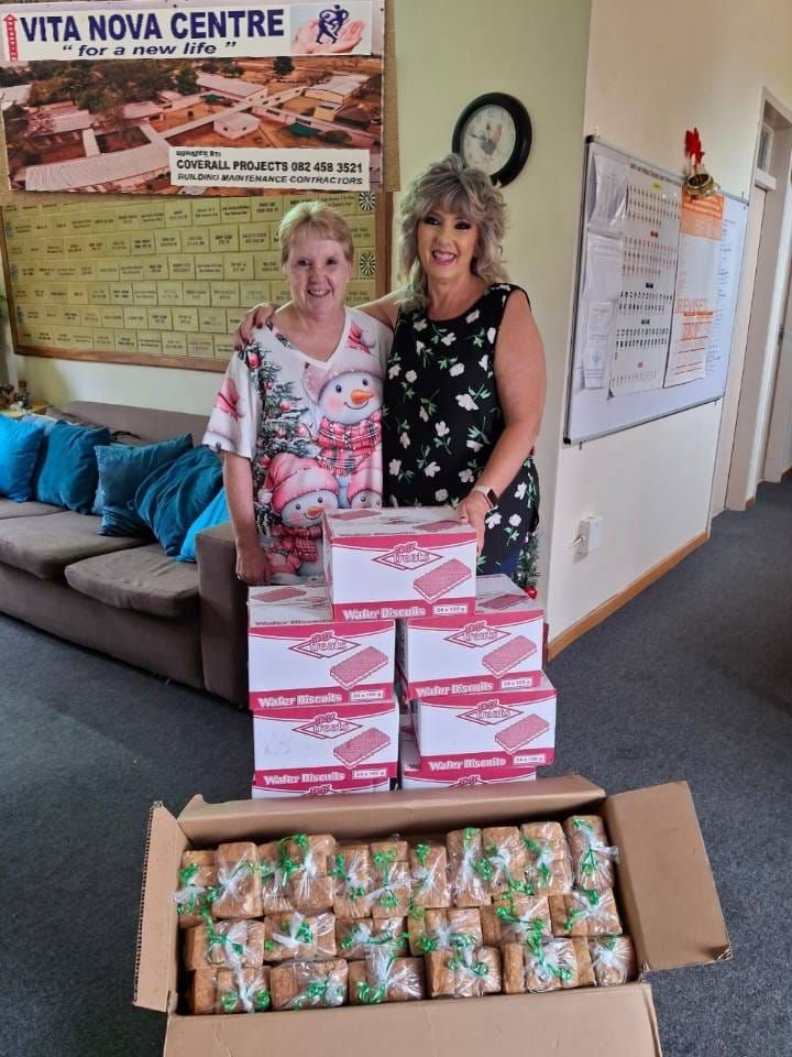 Martie de Villiers from Rise and Restore Project NPC donating rusks and biscuits to Michelle Immelman from Vita Nova Center