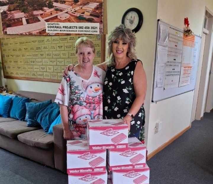 Martie de Villiers from Rise and Restore Project NPC donating rusks and biscuits to Michelle Immelman from Vita Nova Center