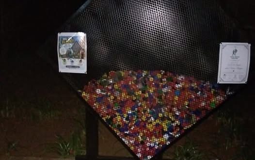 A photo of collected bottle caps for Vita Nova's bottlecap drive