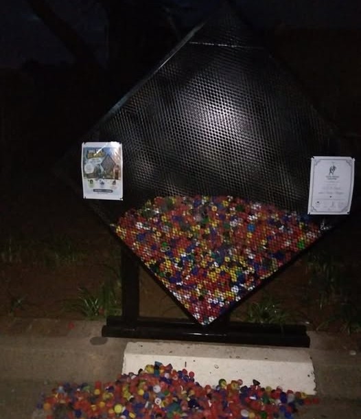 A photo of collected bottle caps for Vita Nova's bottlecap drive
