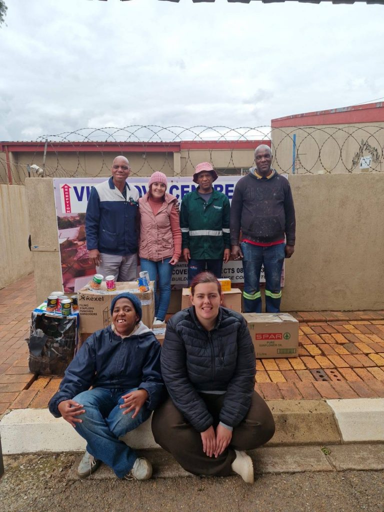 Nadia Immelman with two of Vita Nova residents and Pinegrove Primary staff and their generous donation