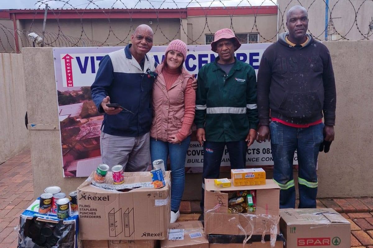 Nadia Immelman standing with Pinegrove Primary staff and their generous donation